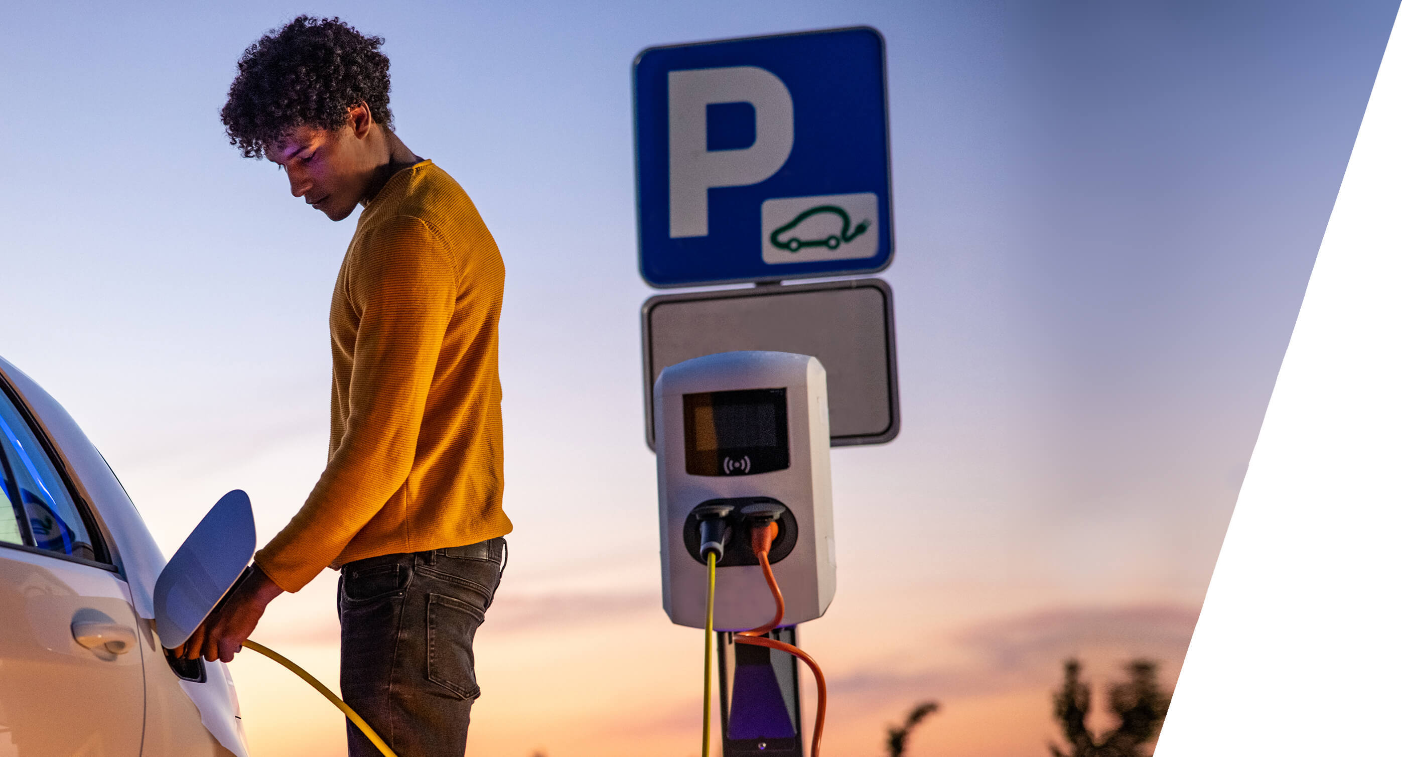 man charging electric car